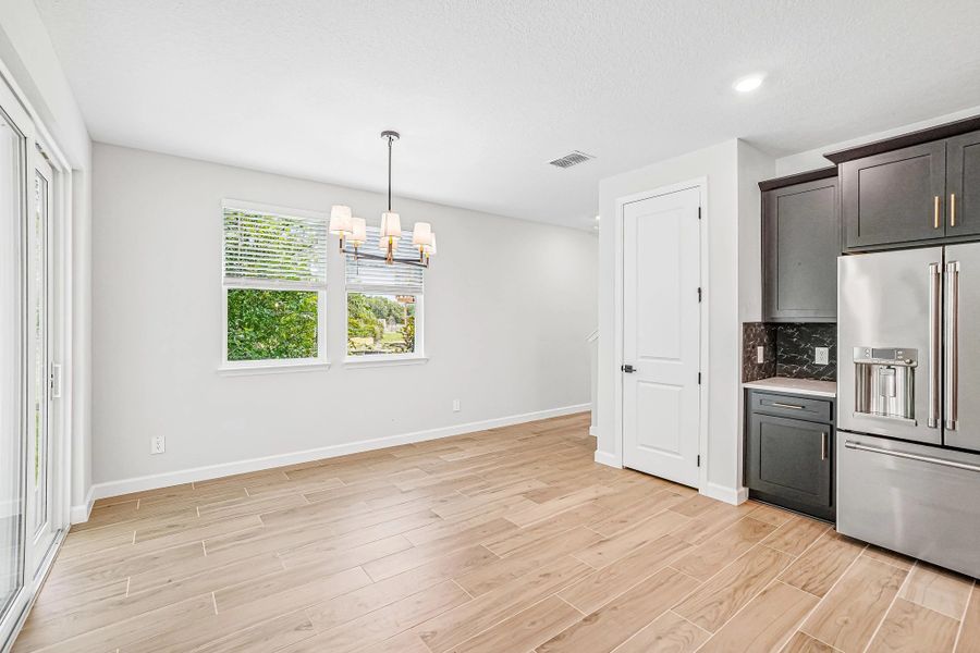 The dining space features two windows and a beautiful light fixture The dining space features two windows and a beautiful light fixture