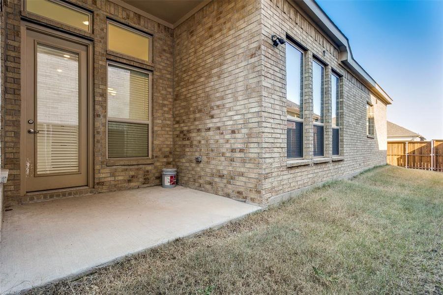 covered patio opens to nice side & backyard lawn area privacy fence