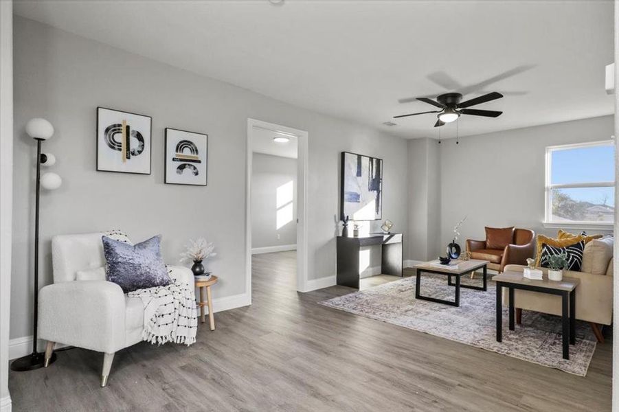 Living room featuring wood-type flooring and ceiling fan