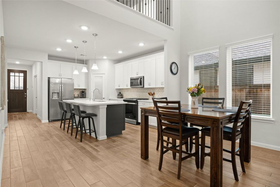 The dining area flows seamlessly between the kitchen and living room. The dining area flows seamlessly between the kitchen and living room.
