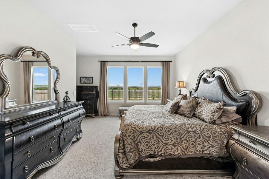 Bedroom featuring light carpet and a ceiling fan