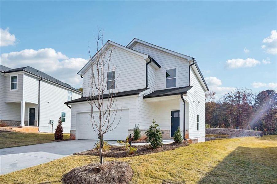 Front exterior of a new home in Avalon - Reserve Series, Conyers, GA, highlighting curb appeal (Image 1).