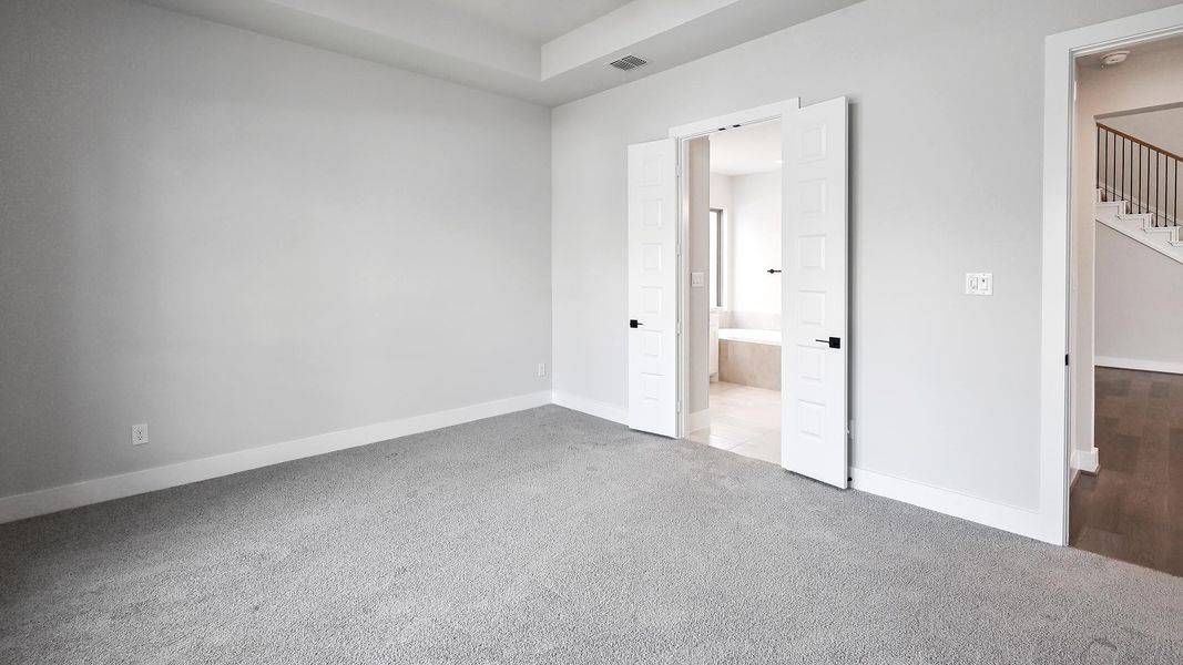 Unfurnished bedroom with carpet flooring and connected bathroom