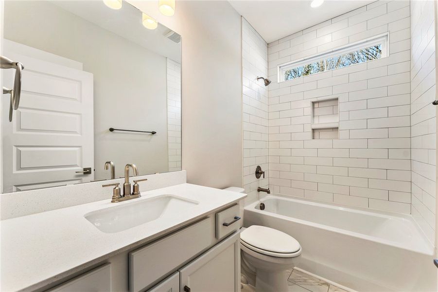 This bright bathroom features subway tile, a spaci This bright bathroom features subway tile, a spaci