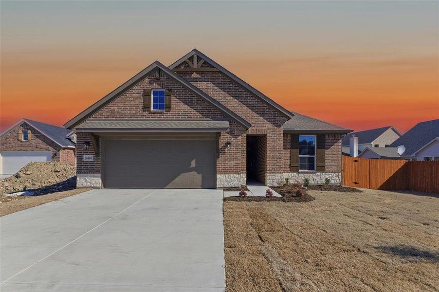 View of front of house featuring brick siding and concrete driveway