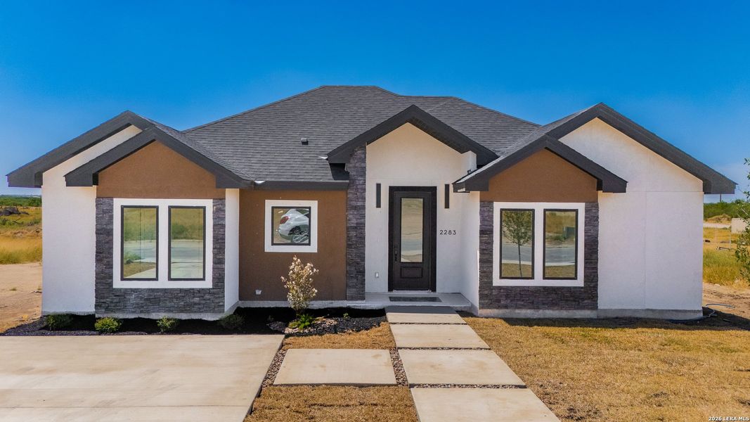 Front exterior of a new home in , Eagle Pass, TX, highlighting curb appeal (Image 22).