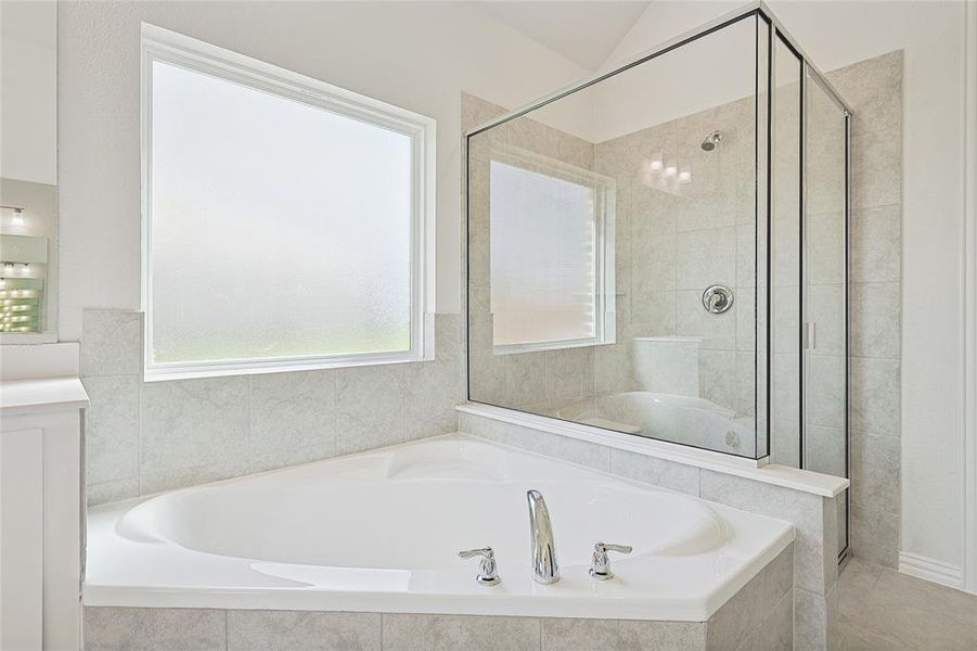 Bathroom with separate shower and tub and lofted ceiling