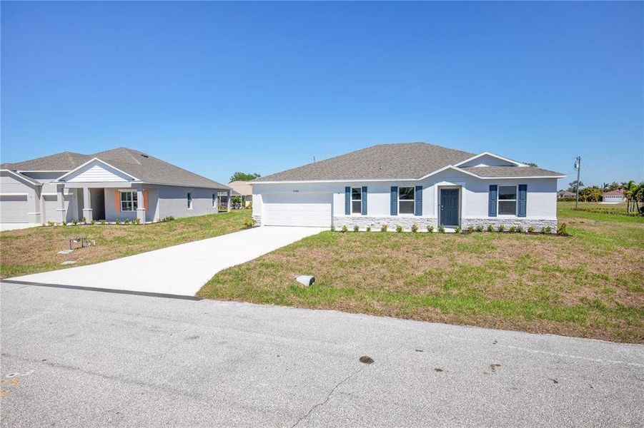Front exterior of a new home in Burnt Store Village, Punta Gorda, FL, highlighting curb appeal (Image 19).