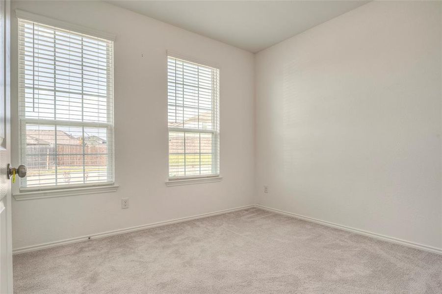 Unfurnished room with light colored carpet and baseboards Unfurnished room with light colored carpet and baseboards