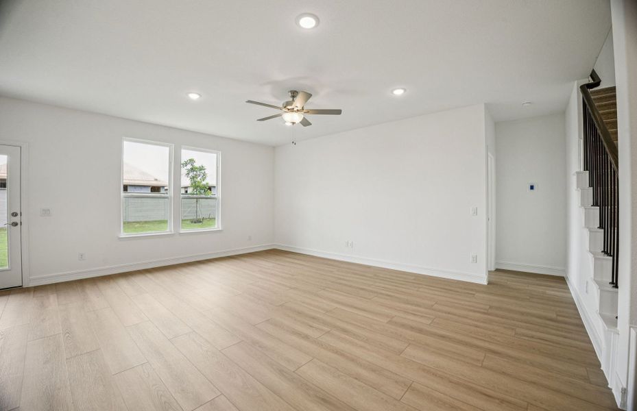 Expansive gathering room bathed in natural sunlight  *Real home pictured