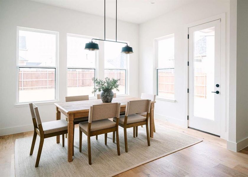 Dining space with light hardwood / wood-style floors