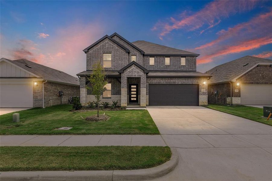Front exterior of a new home in Stratton Place, Greenville, TX, highlighting curb appeal (Image 1).
