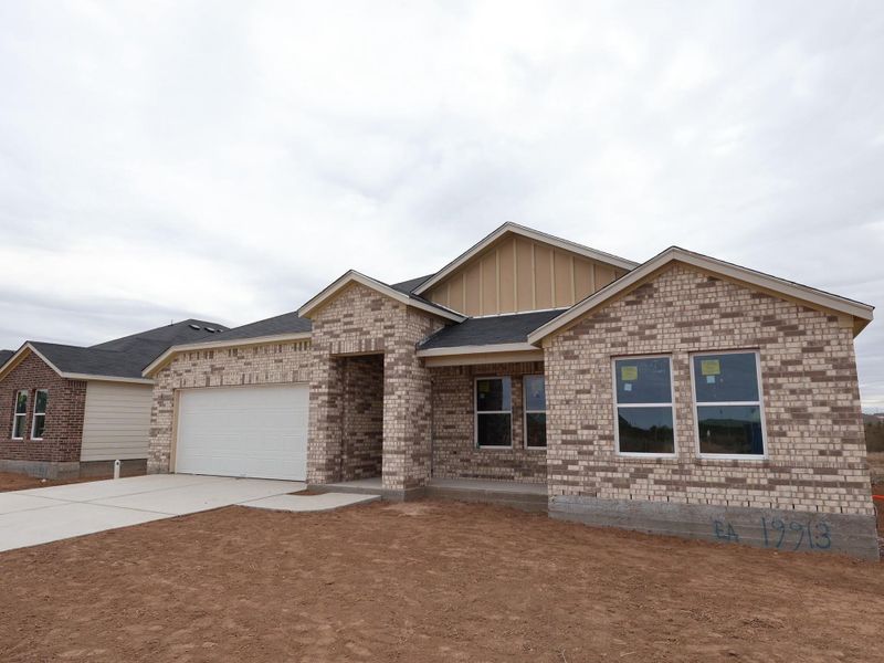 Front exterior of a new home in Carillon, Manor, TX, highlighting curb appeal (Image 7).
