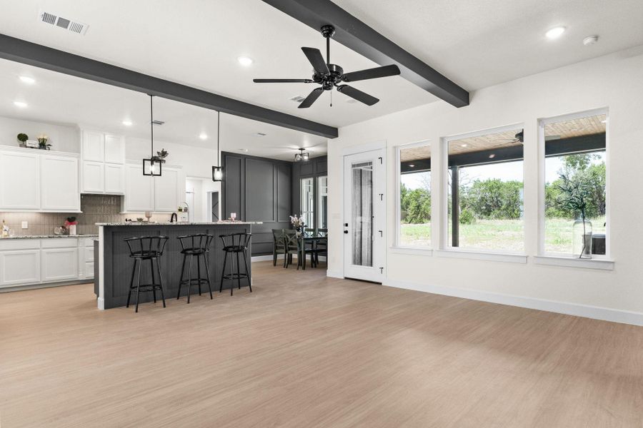 Living room featuring ceiling fan, light wood-style flooring, beam ceiling, and recessed lighting