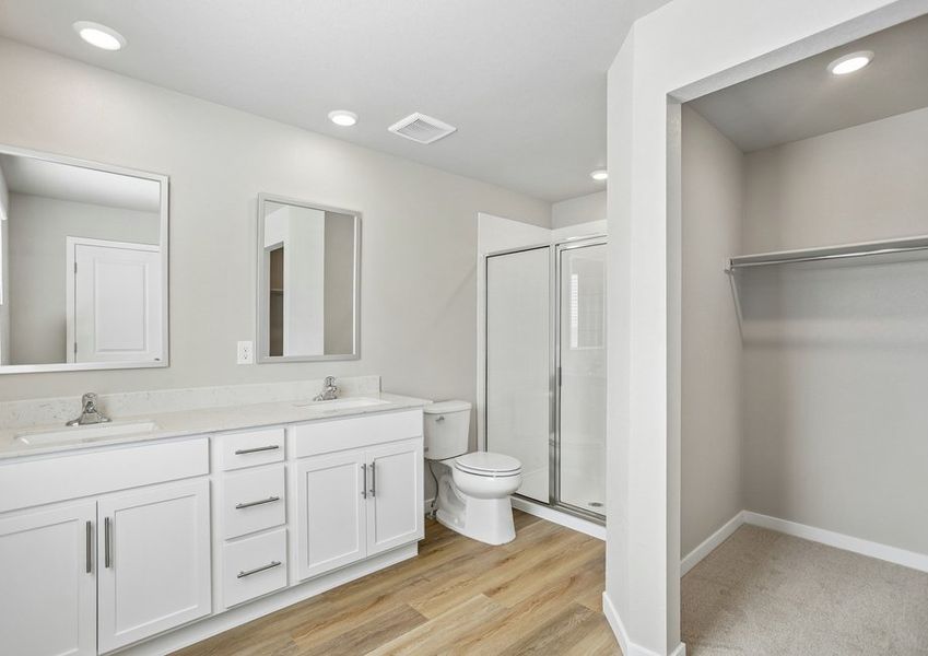 The master bath has a dual sink vanity and step in shower.