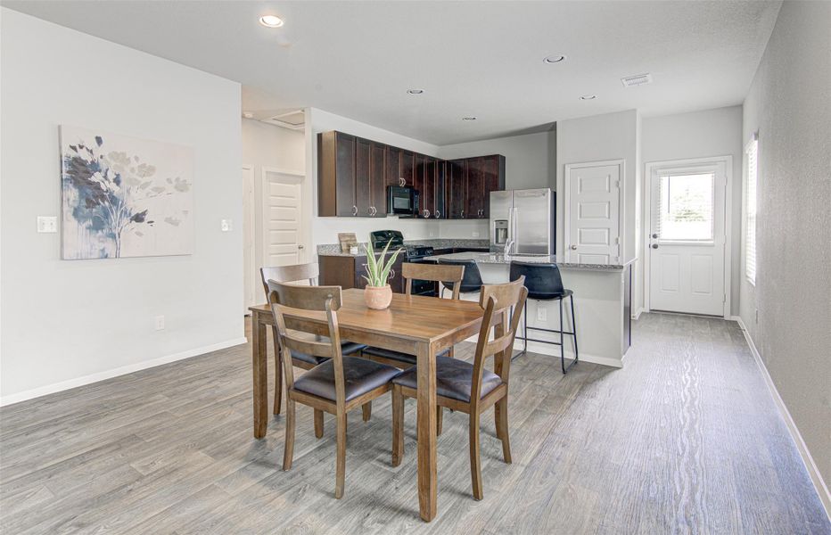 An open-concept living space integrates a well-appointed kitchen with a comfortable dining area, perfect for daily meals. An open-concept living space integrates a well-appointed kitchen with a comfortable dining area, perfect for daily meals.