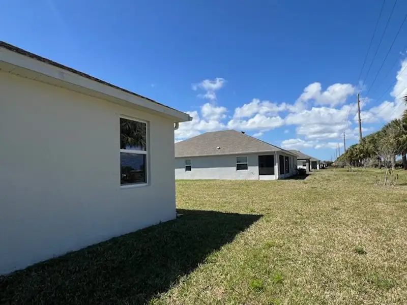 Exterior details and patio area of a home in Lakes At St Sebastian, Micco (Image 3).