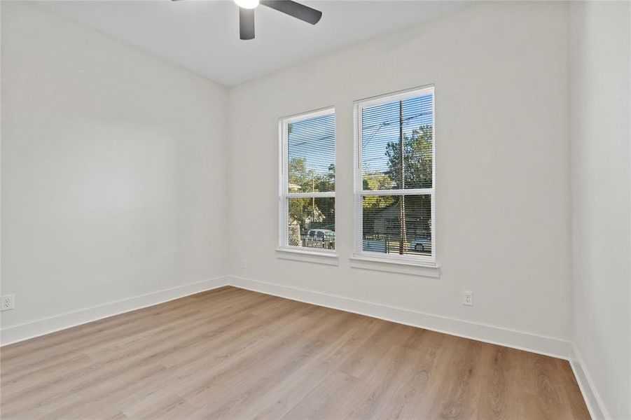 Empty room featuring light wood-type flooring and ceiling fan