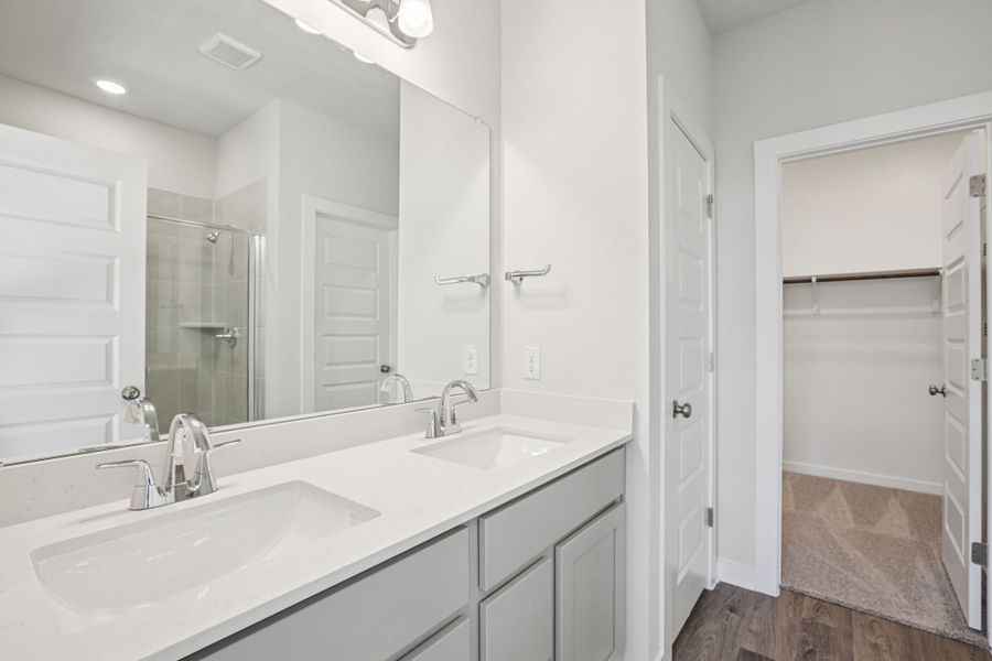 A bathroom with a large mirror. A bathroom with a large mirror.