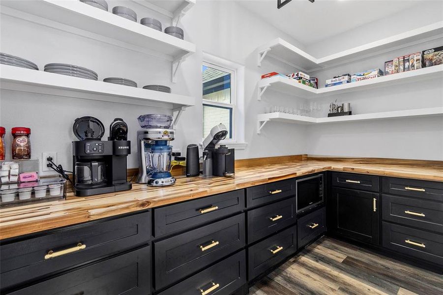 Inside the butler's pantry with additional storage, floating shelves, butcher block counters and microwave