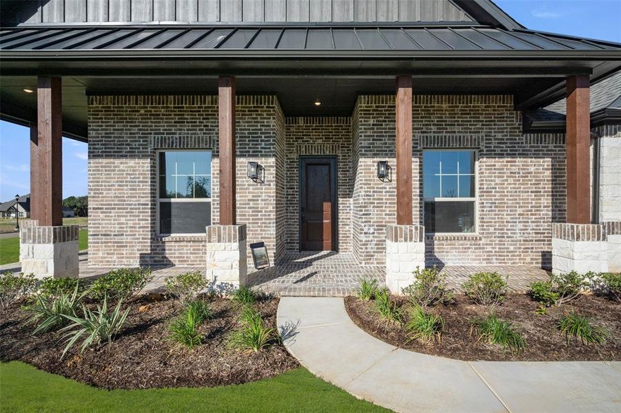 close up of front of home with entry way and front porch.