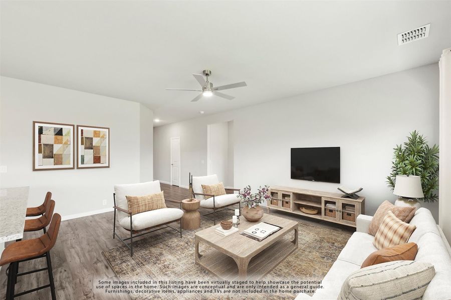 Living room with hardwood floors, ceiling fan, wall-mounted TV, and neutral furniture seating area