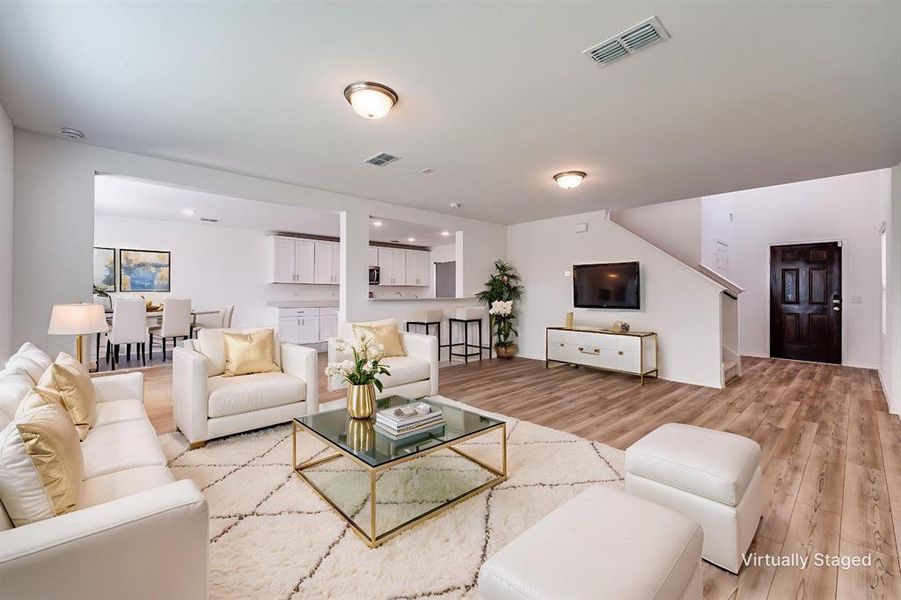 Living room open to dining area and kitchen - virtually staged Living room open to dining area and kitchen - virtually staged
