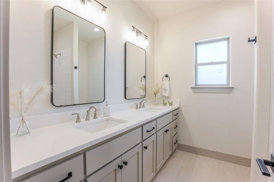 Secondary bathroom between bedrooms 2 and 3. Double vanities and custom cabinetry add to the charm of the bathroom. Secondary bathroom between bedrooms 2 and 3. Double vanities and custom cabinetry add to the charm of the bathroom.