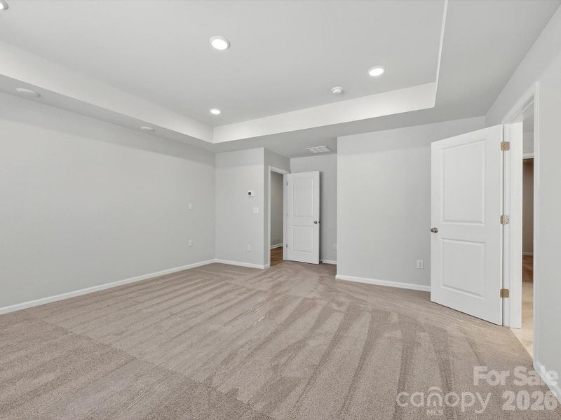 Owners bedroom features tray ceiling