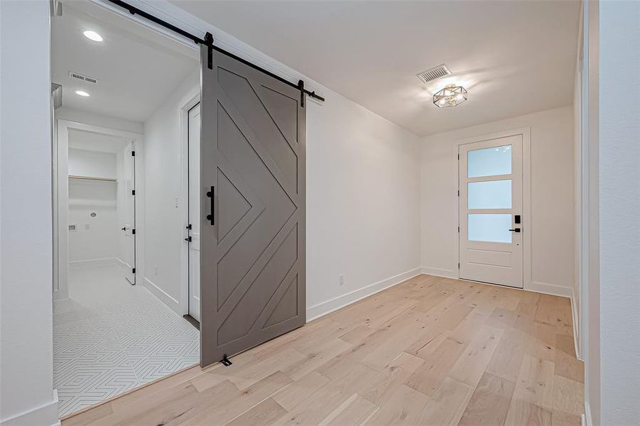 Front door & view to the garage entry