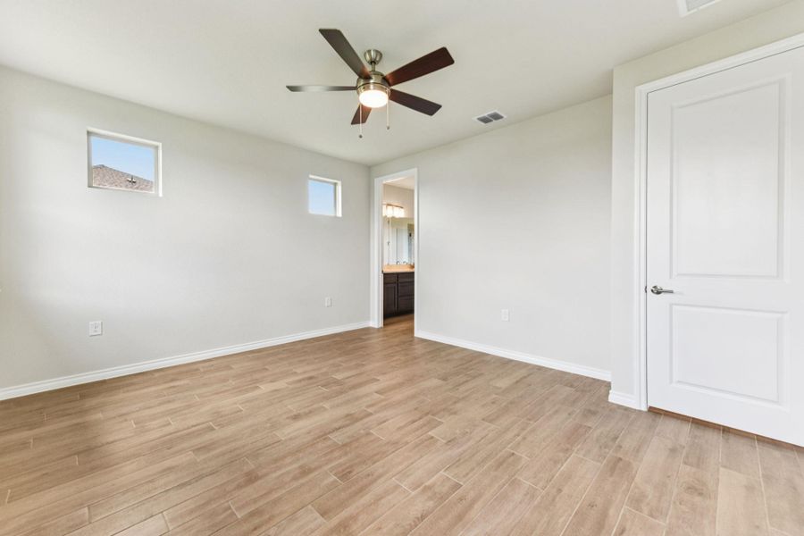 Spare room featuring light wood-type flooring and a ceiling fan