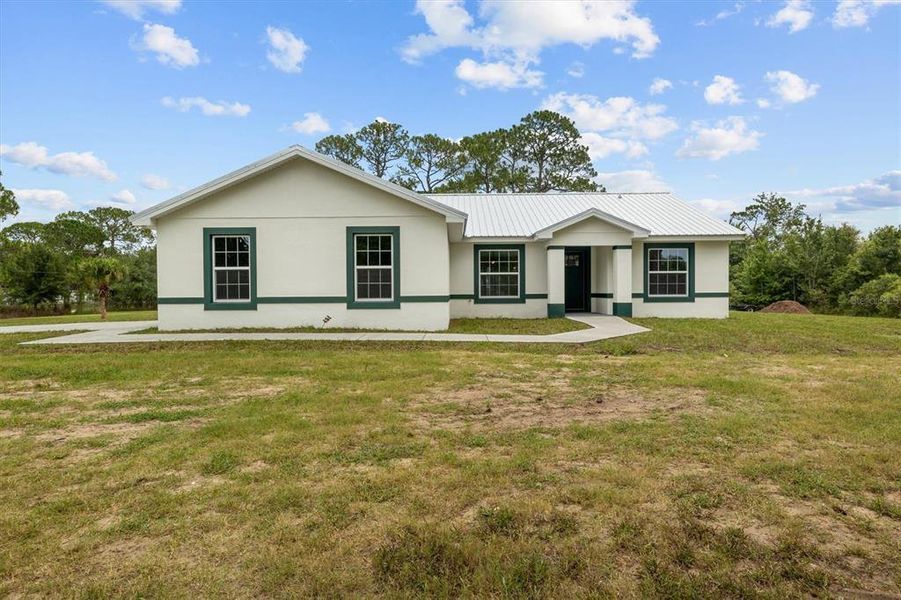 Front exterior of a new home in , Haines City, FL, highlighting curb appeal (Image 23).