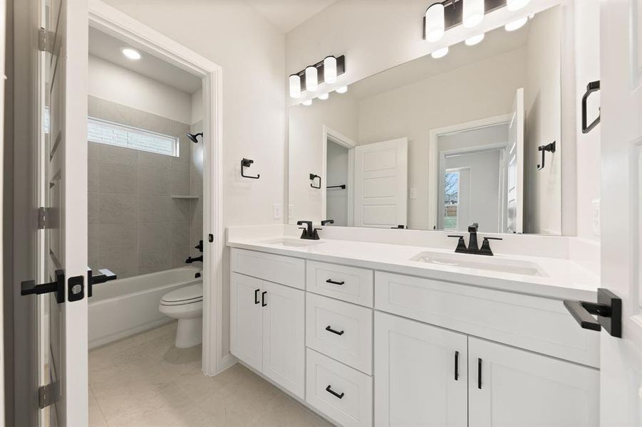 Guests will enjoy their own vanity space in this thoughtfully designed guest bath.