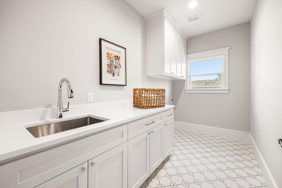 Upstairs laundry room with sink. Upstairs laundry room with sink.