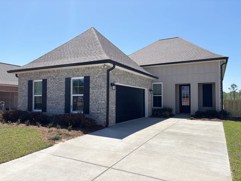 Front exterior of a new home in Natureview, Freeport, FL, highlighting curb appeal (Image 1). Front exterior of a new home in Natureview, Freeport, FL, highlighting curb appeal (Image 1).
