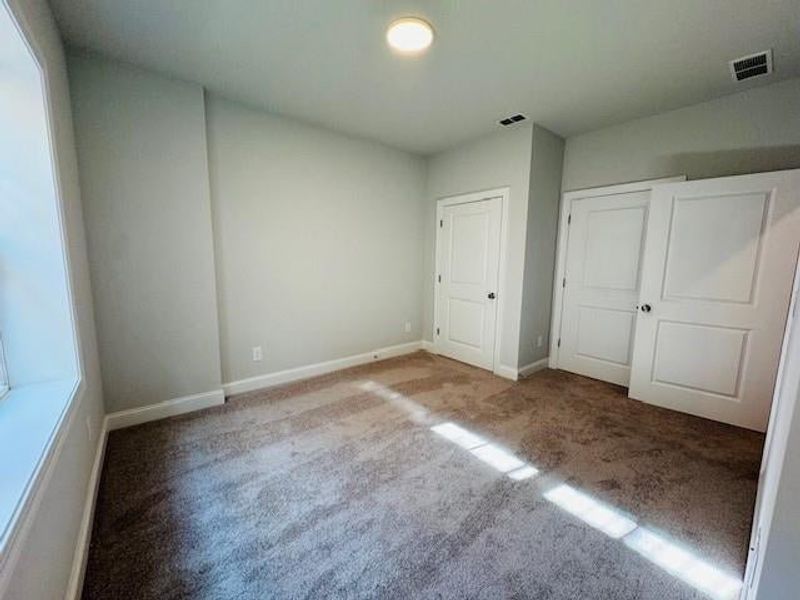 The secondary bedroom on the 1st floor of the home.