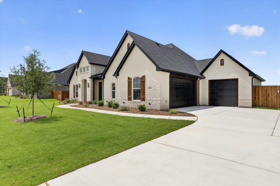 Front exterior of a new home in Coyote Crossing, Godley, TX, highlighting curb appeal (Image 2).