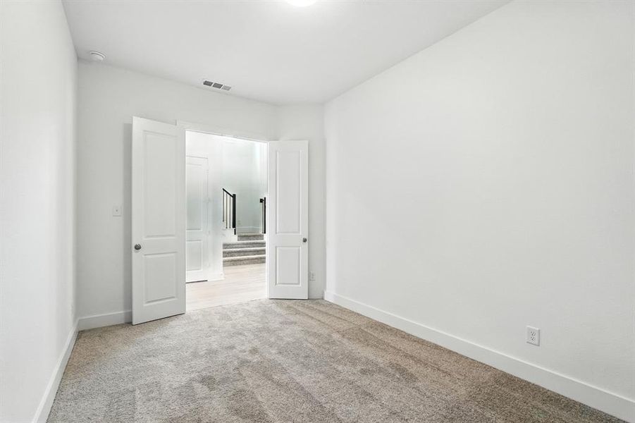 Unfurnished bedroom featuring light carpet and baseboards Unfurnished bedroom featuring light carpet and baseboards