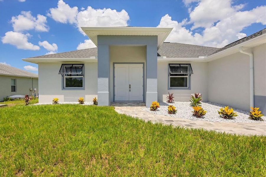 Front exterior of a new home in , Port Charlotte, FL, highlighting curb appeal (Image 21). Front exterior of a new home in , Port Charlotte, FL, highlighting curb appeal (Image 21).