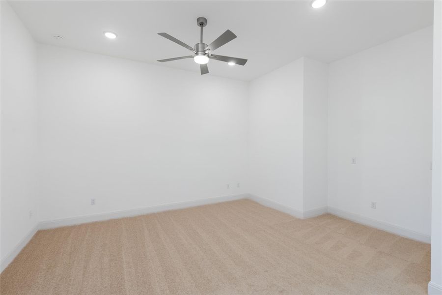 Spare room featuring light carpet, recessed lighting, and ceiling fan