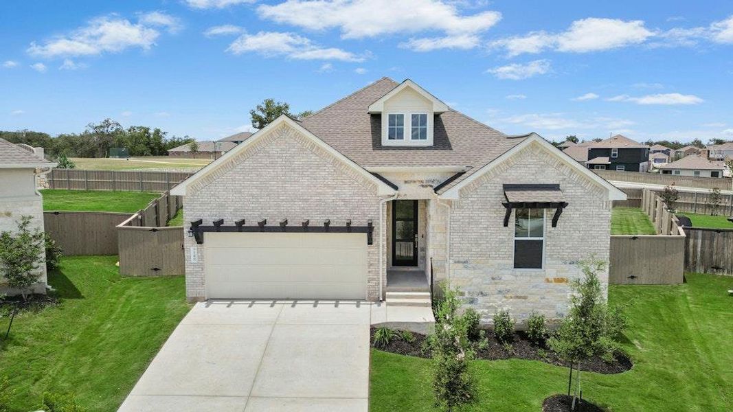 Front exterior of a new home in The Colony, Bastrop, TX, highlighting curb appeal (Image 2).