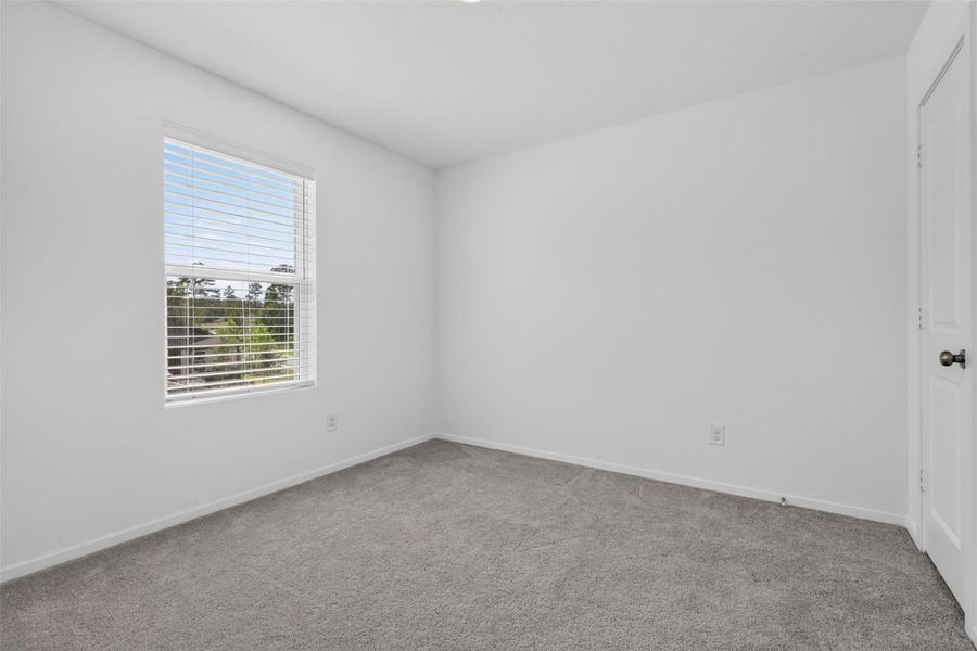 Second bedroom, in this 4/2.5 Home for sale in Magnolia ISD