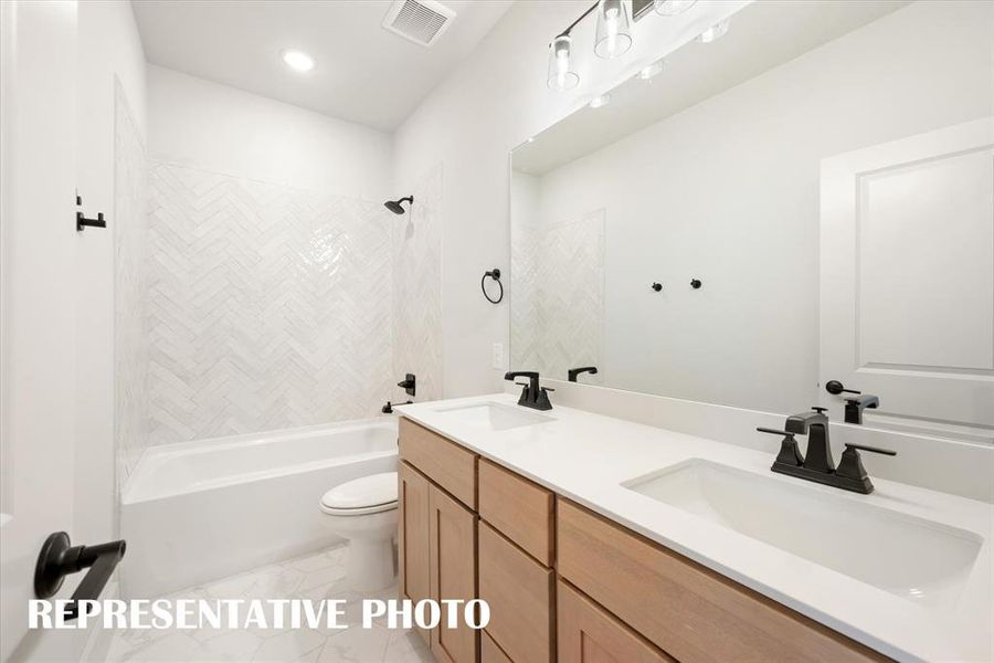 Guests will enjoy their own space in this beautiful guest bath featuring dual sinks!  REPRESENTATIVE PHOTO