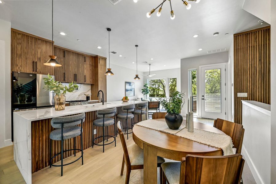 Plenty of space to gather for a meal. (This is Unit #2 - each Unit has the same layout, however a few differing details such as light fixtures, custom cabinet/backsplash/tile colors)