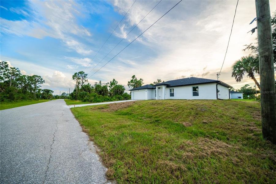 Front exterior of a new home in , Port Charlotte, FL, highlighting curb appeal (Image 15).