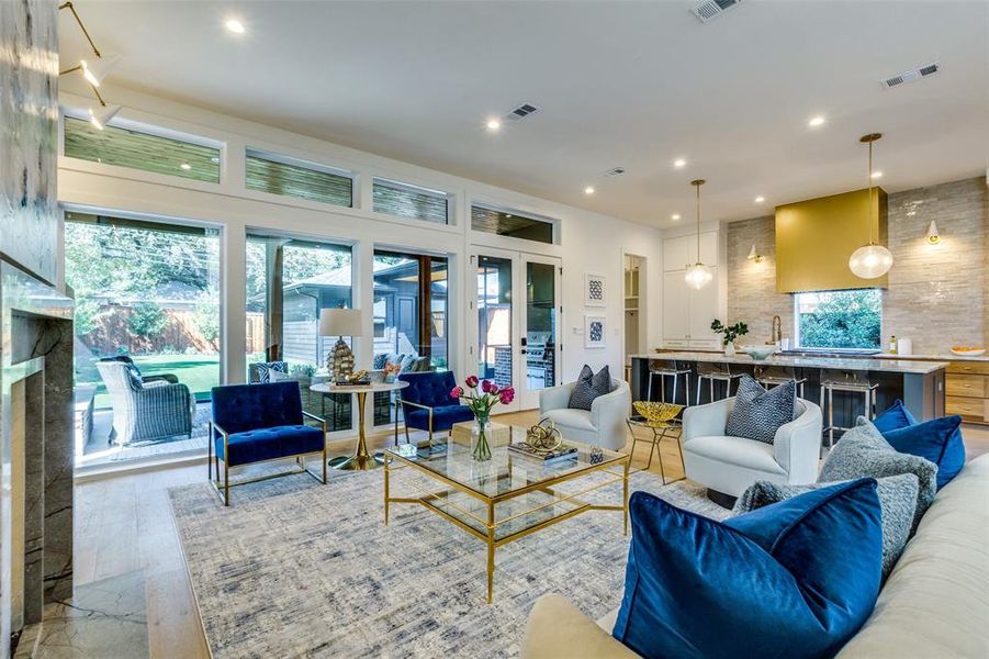 living room with floor to ceiling windows to view patio & backyard