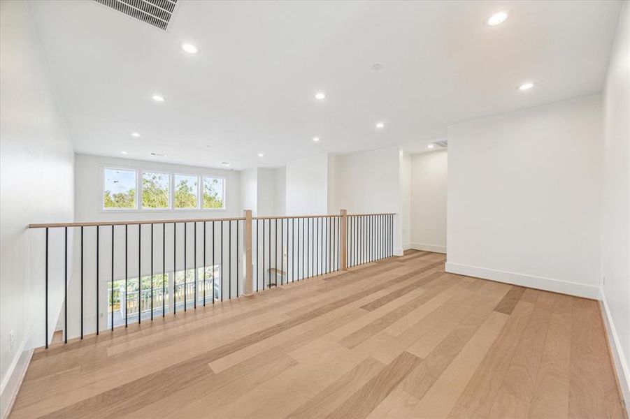 The upstairs loft is an ideal spot for a secondary workspace, homework station, or reading nook. Nestled between the three bedrooms, it overlooks the family room, creating a cozy and connected feel. Photo as of 11/5/2024