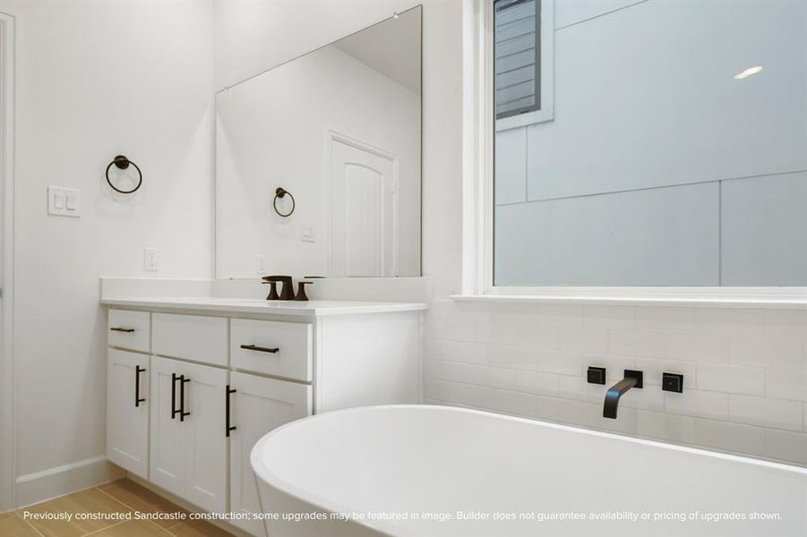 A close-up of the vessel bathtub offers a glimpse into tranquil moments waiting in the privacy of your ensuite retreat.