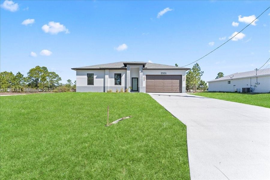Front exterior of a new home in , Lehigh Acres, FL, highlighting curb appeal (Image 5).