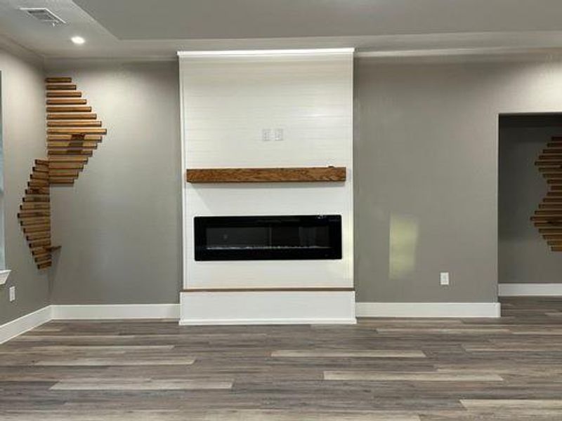 Unfurnished living room with hardwood / wood-style flooring